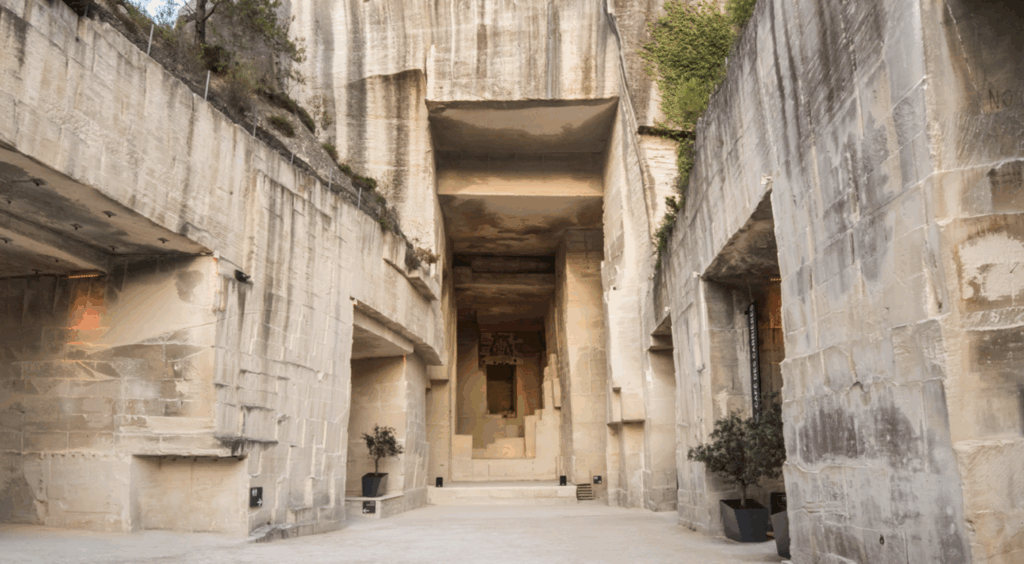 Unique intimate ceremony venue at Les Carrières de Lumières in Les Baux-de-Provence, historic limestone quarries transformed into immersive art space with 70-foot high walls