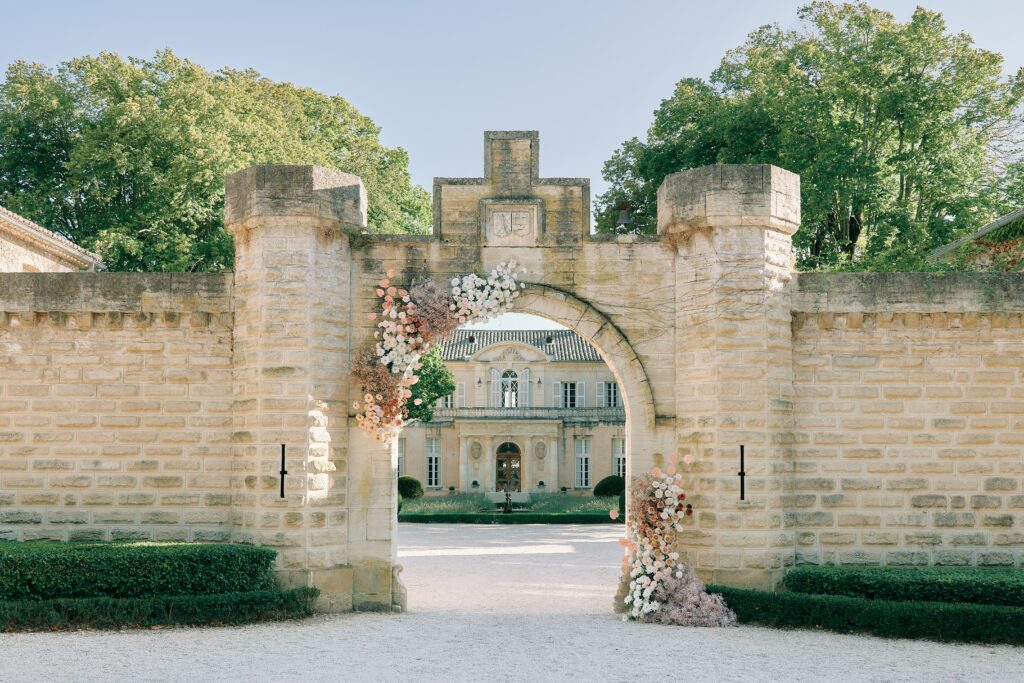 Intimate luxury elopement ceremony in private Provence château garden, couple exchanging vows during golden hour