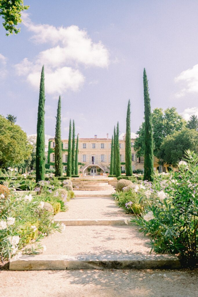 Chateau d'Estoublon wedding ceremony in Provence, French garden and chateau courtyard setting.