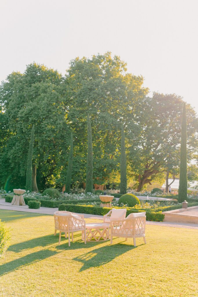 Elegant wedding details at Chateau d'Estoublon—welcome party with lounges in the gardens, all facing the Chateau.