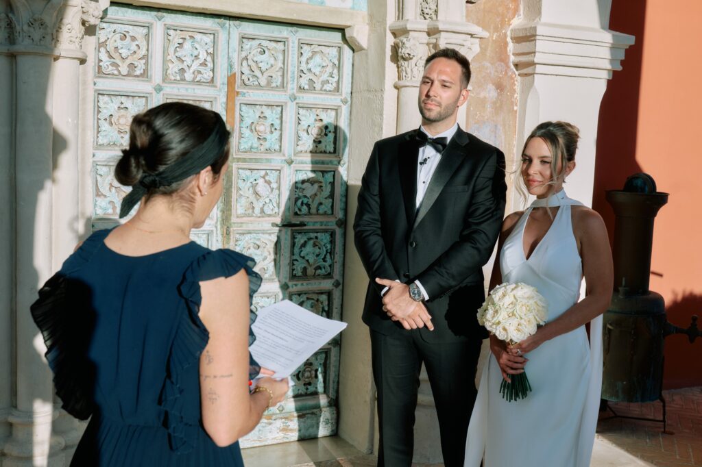 Krista and Mark listening to their officiant during their South of France elopement ceremony